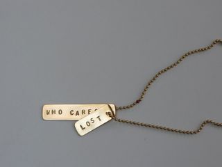 'Who Cares / Lost' tag in 22 carat gold