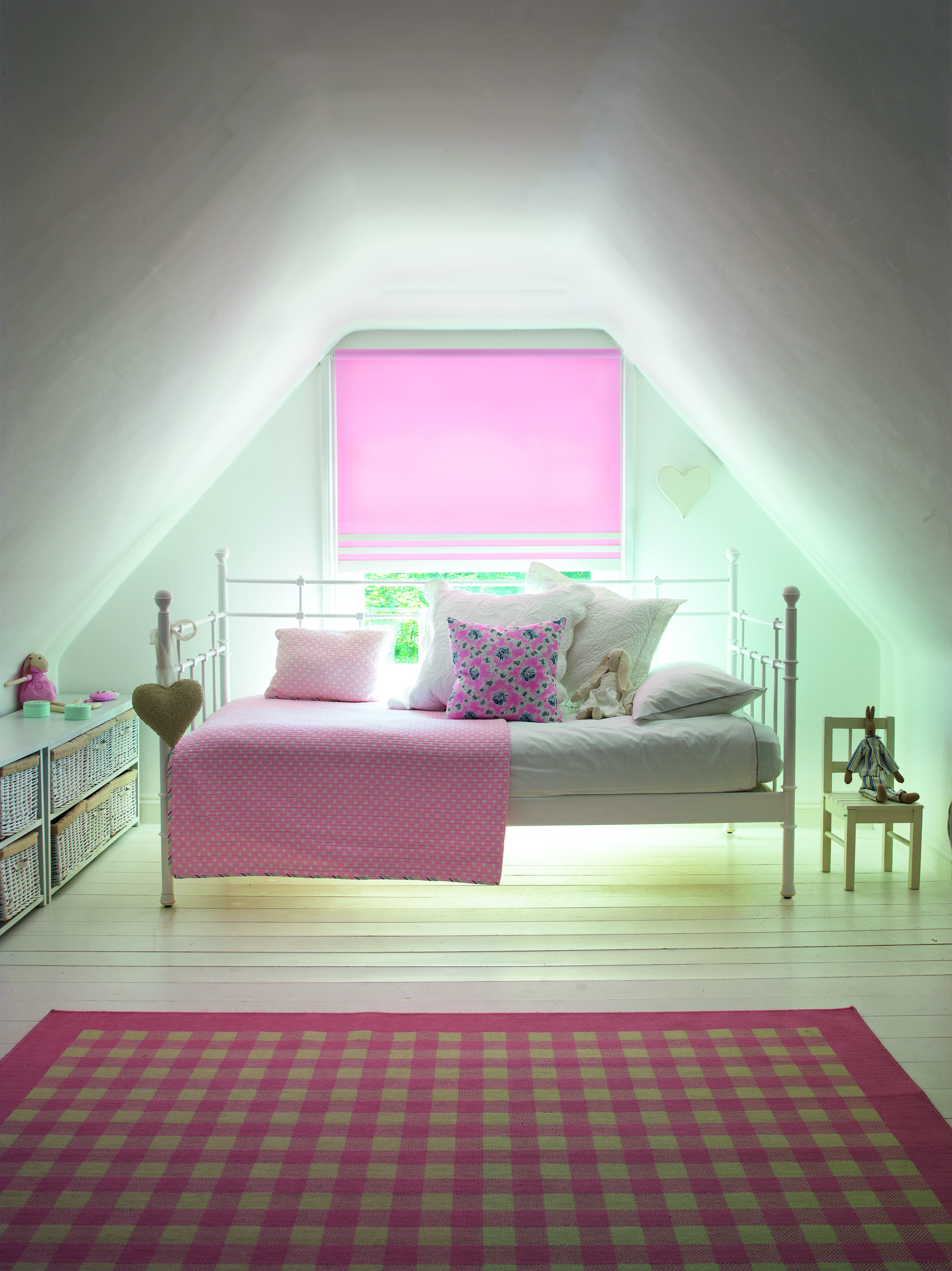 white bedroom with pink blind, check rug, day bed, pink blanket, bedroom storage