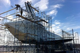 Temporary scaffolding is seen being raised around Enterprise on the flight deck of the Intrepid Sea, Air and Space Museum.