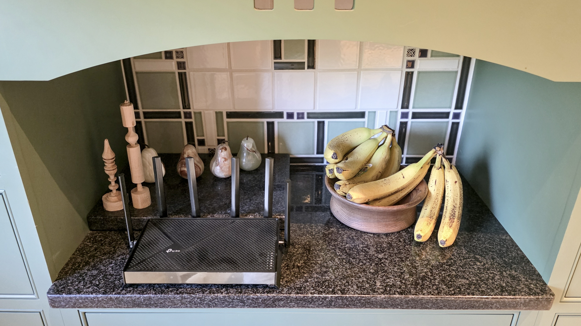 TP-Link Archer BE9700 router on a kitchen surface