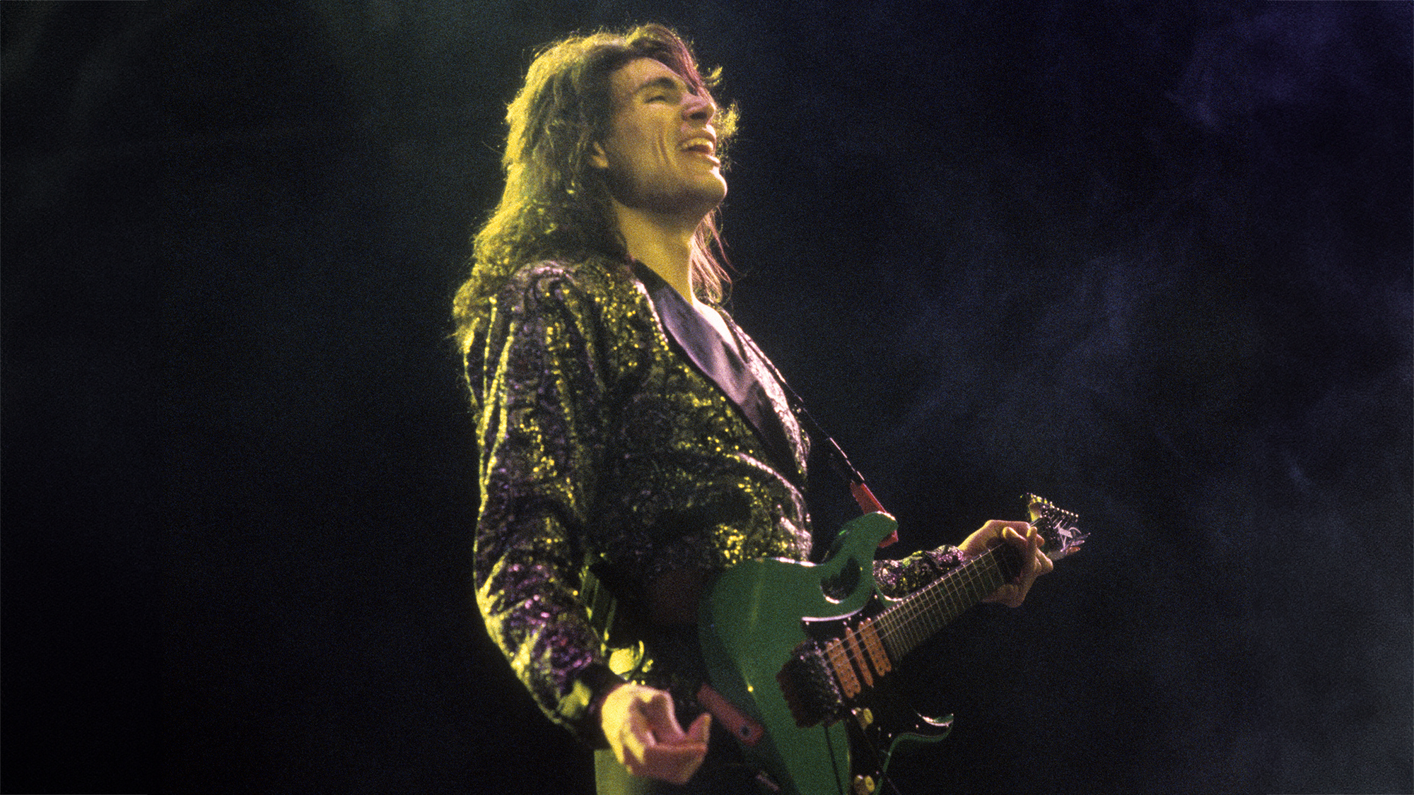 Steve Vai performing with David Lee Roth at the Oakland Coliseum in 1986.