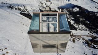 Cabin Of Cable Car Against Snow Covered Mountain