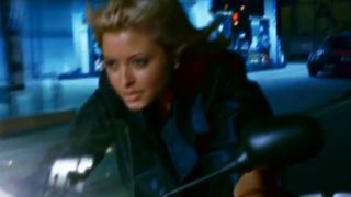 A scene of a woman on a motorcycle in DOA: Dead Or Alive