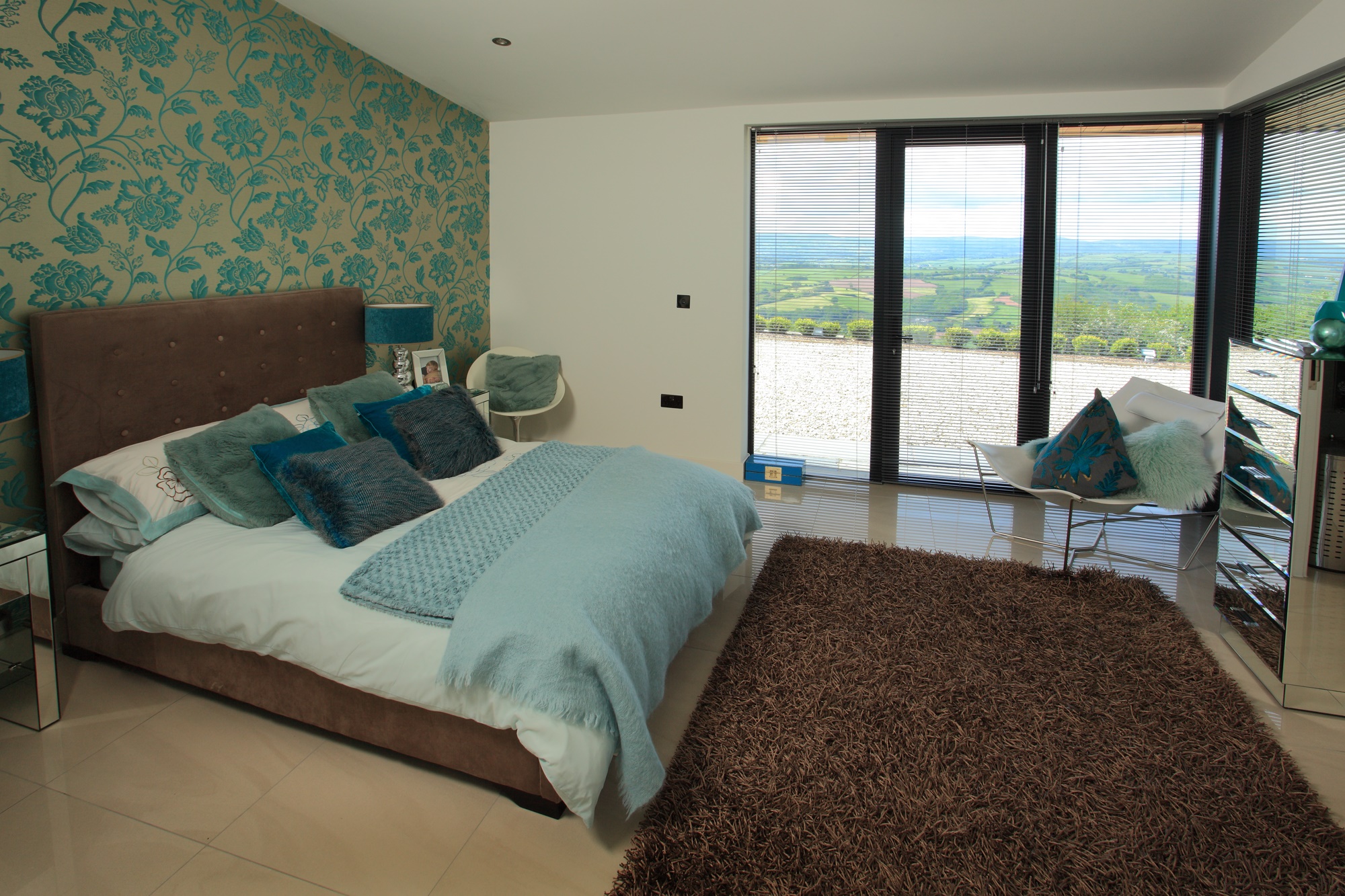 Bedroom with green feature wall inside listed hunting lodge