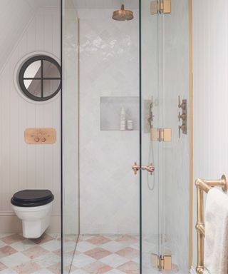 Small white bathroom with walk in shower and checkerboard floor tiles