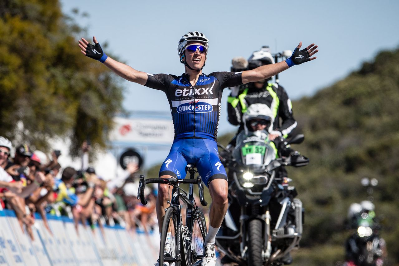 Julian Alaphilippe raises his arms in triumph