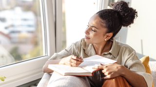 Woman writing in a notepad