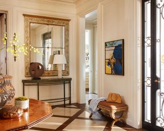 entryway with warm white walls, traditional decor