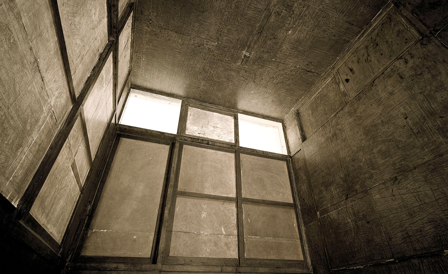 Grey brown walls and dirty windows