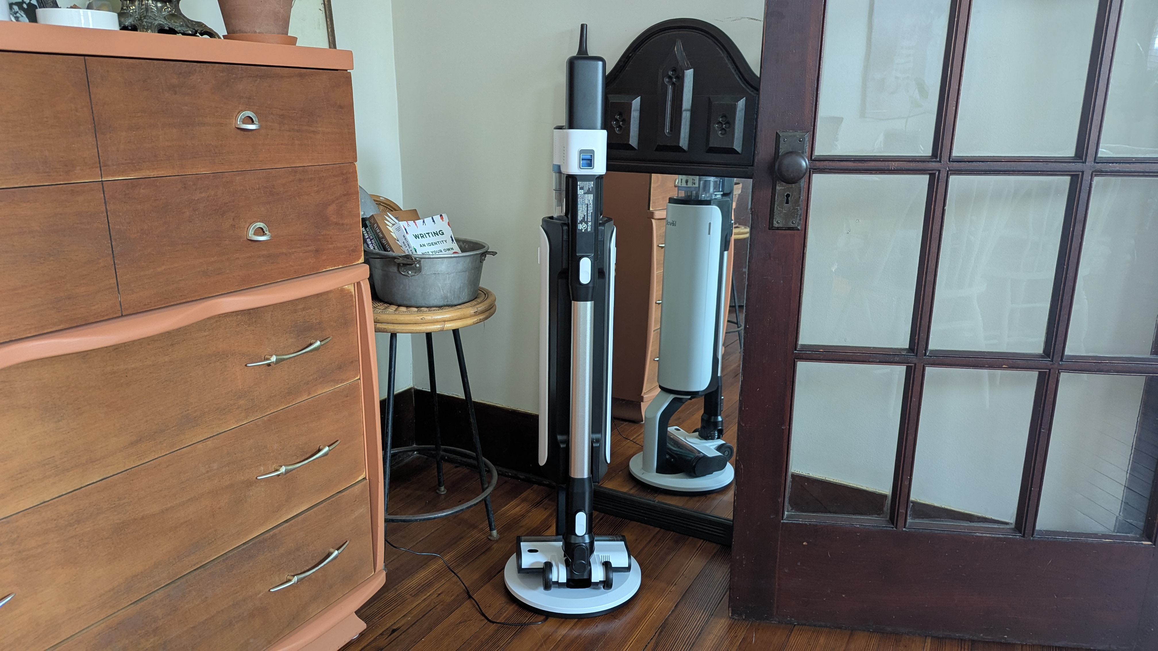 Levoit Aero vacuum in its charge / auto-empty dock, in reviewer's lounge