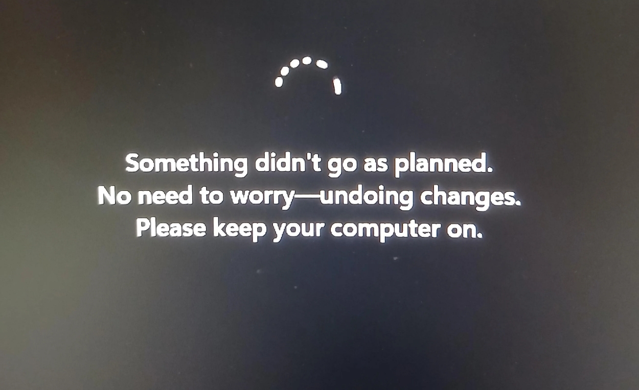A computer screen displays a message: &amp;quot;Something didn't go as planned. No need to worry&amp;ndash;undoing changes. Please keep your computer on.&amp;quot; A loading circle is shown above.