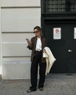 Woman wearing With Nothing Underneath brown shirt, jeans, and white T-shirt.