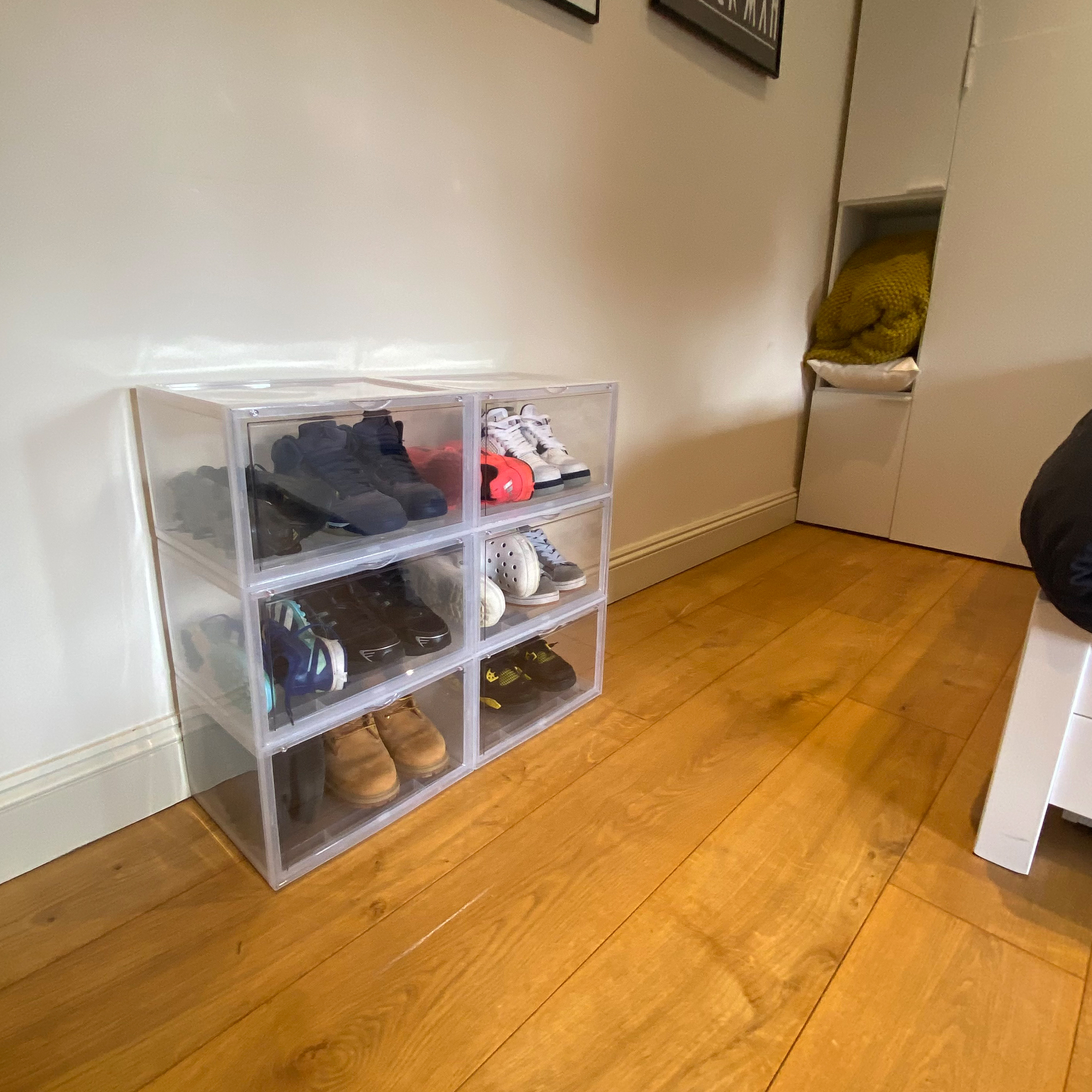A pile of shoes on a kids bedroom floor
