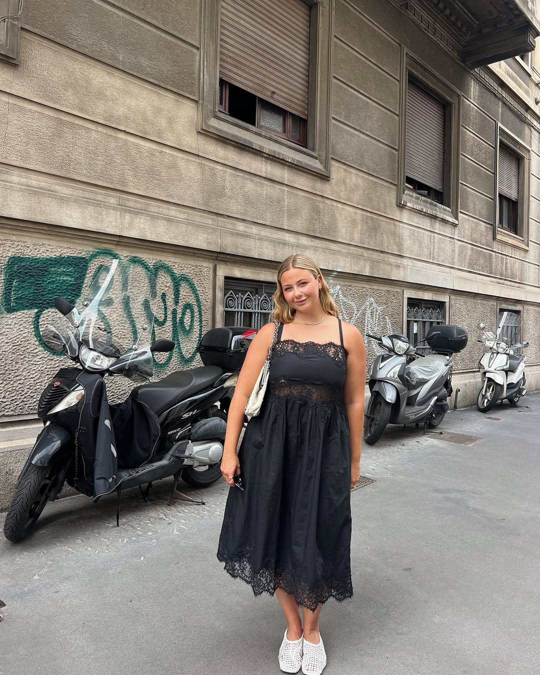 @oliviamarcus wearing black dress and mesh flats