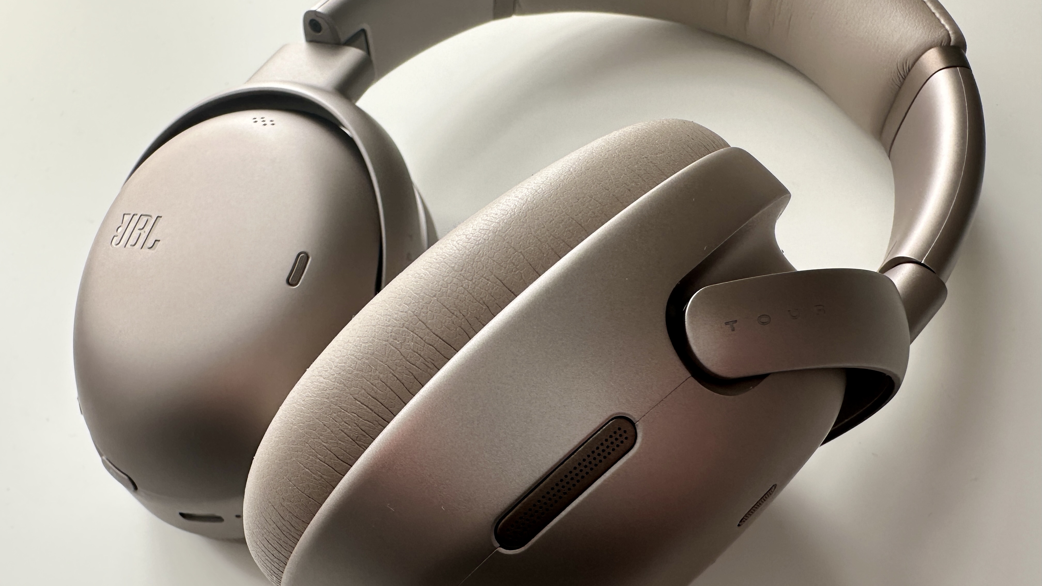 JBL Tour One M3 over-ear noise-cancelling headphones on a white surface