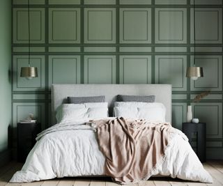 A bedroom with green faux pannelling wallpaper on the back wall