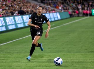 Christen Press dribbling the ball