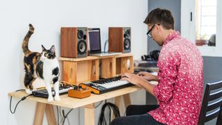 Man playing music with cat