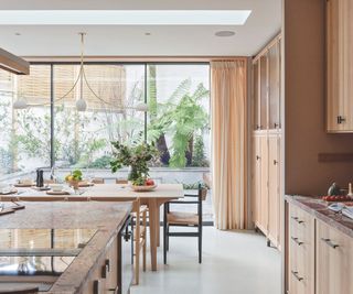 Modern neutral kitchen with lots of wood and orange marble