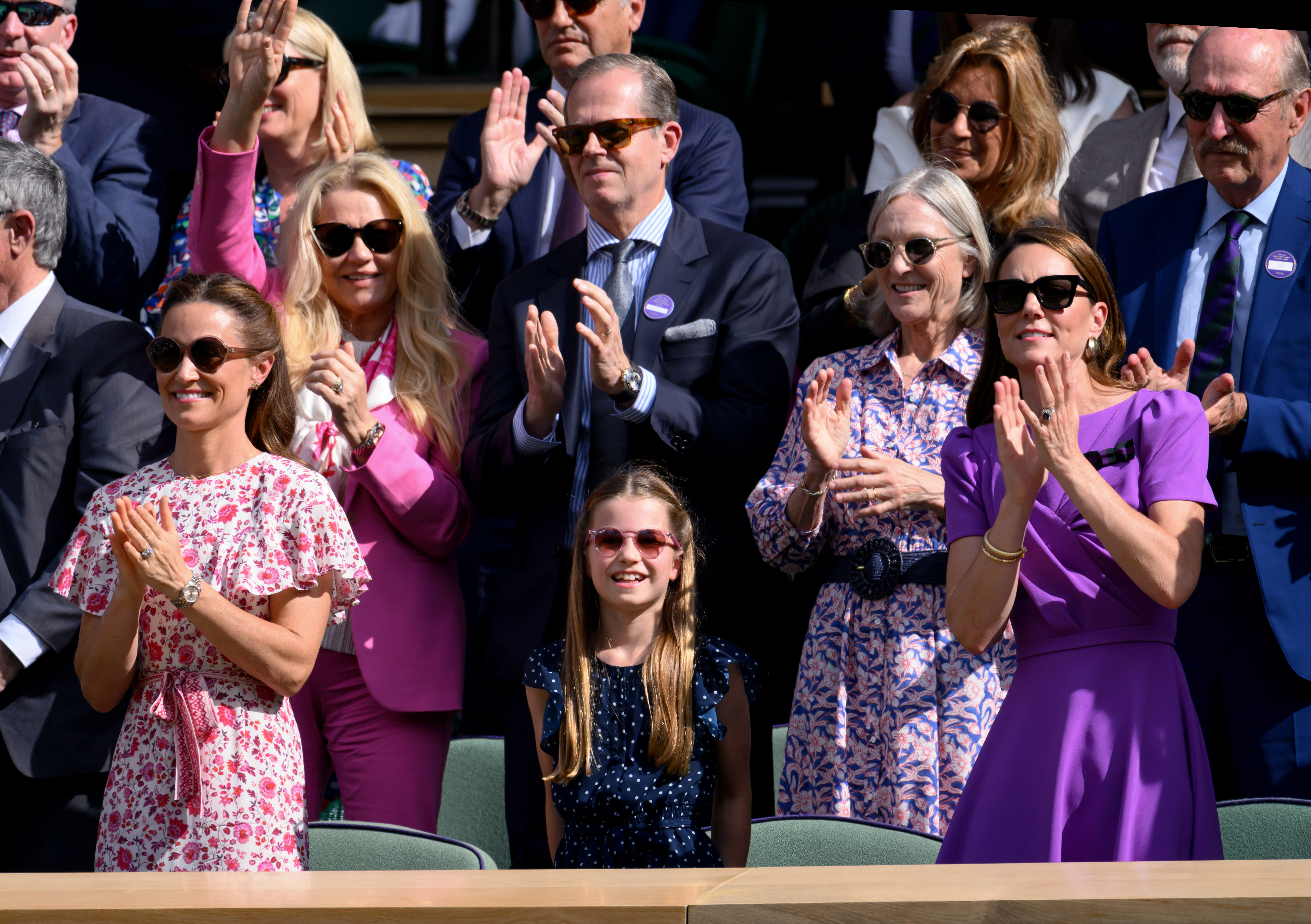 Pippa Middleton, Princess Charlotte and Princess Kate standing up clapping at Wimbledon