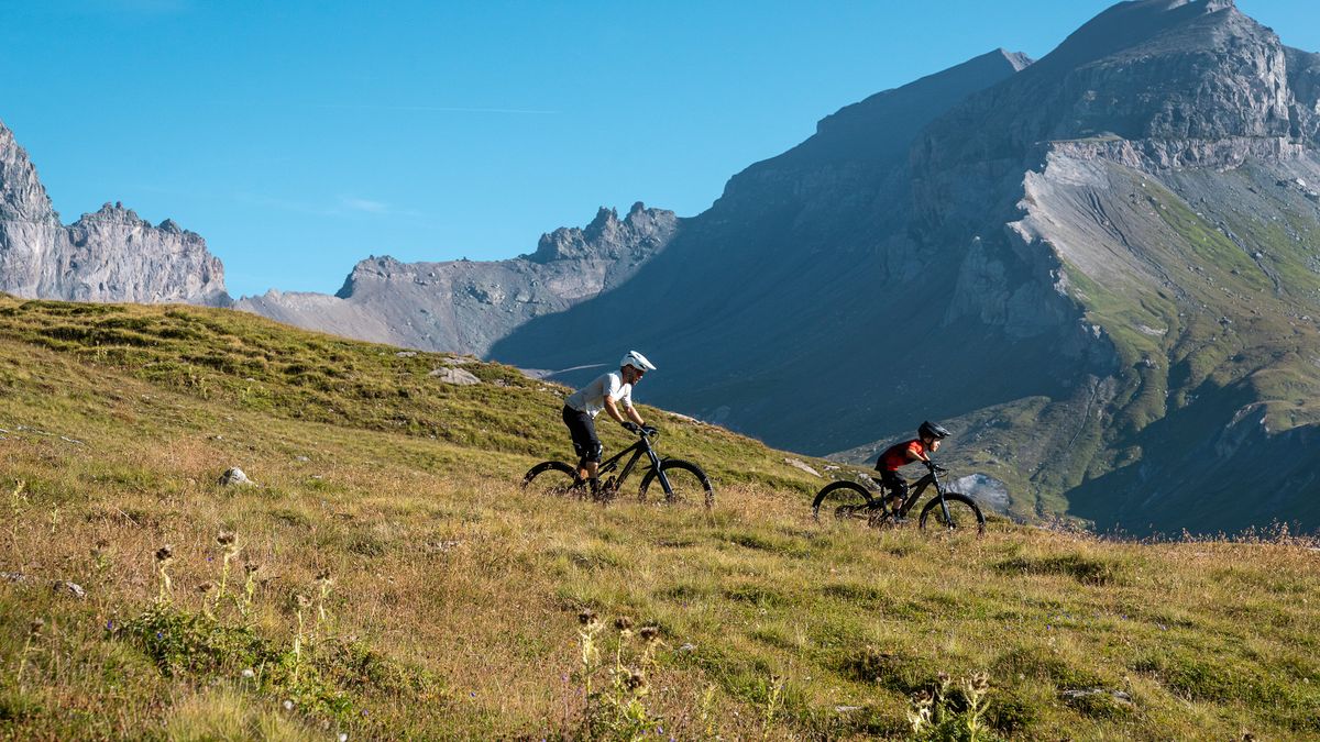 Father and child riding MTBs in the mountains