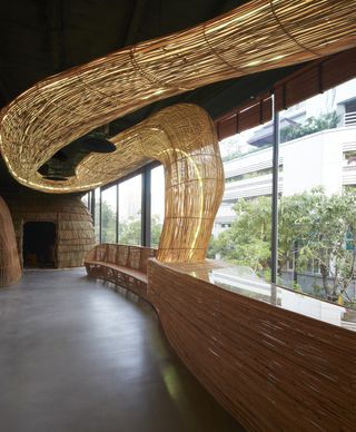 Interior view of Vikasa yoga studio with curved 3D tubular lighting feature and seating area