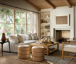 mcgee & co spring living room with a wooden panel ceiling, large fireplace and a sofa white couch