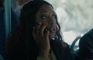 Ronke Adekoluejo on the phone while riding a bus