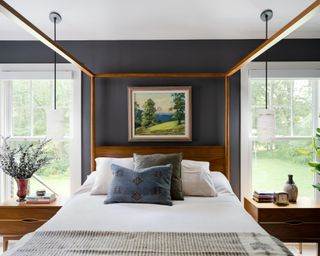 bedroom with charcoal gray feature wall and four poster bed