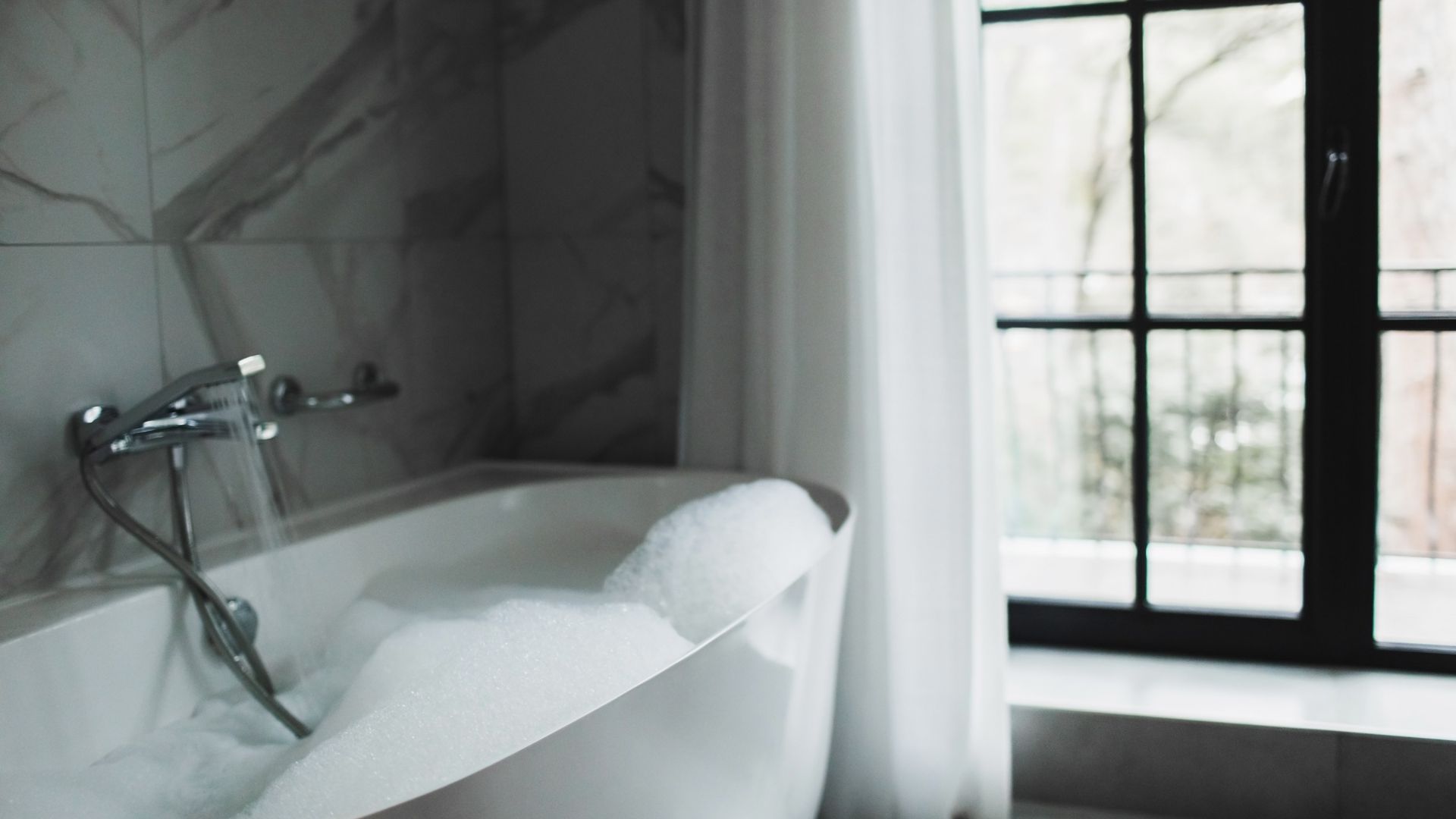 picture of marble bathroom with bath running water