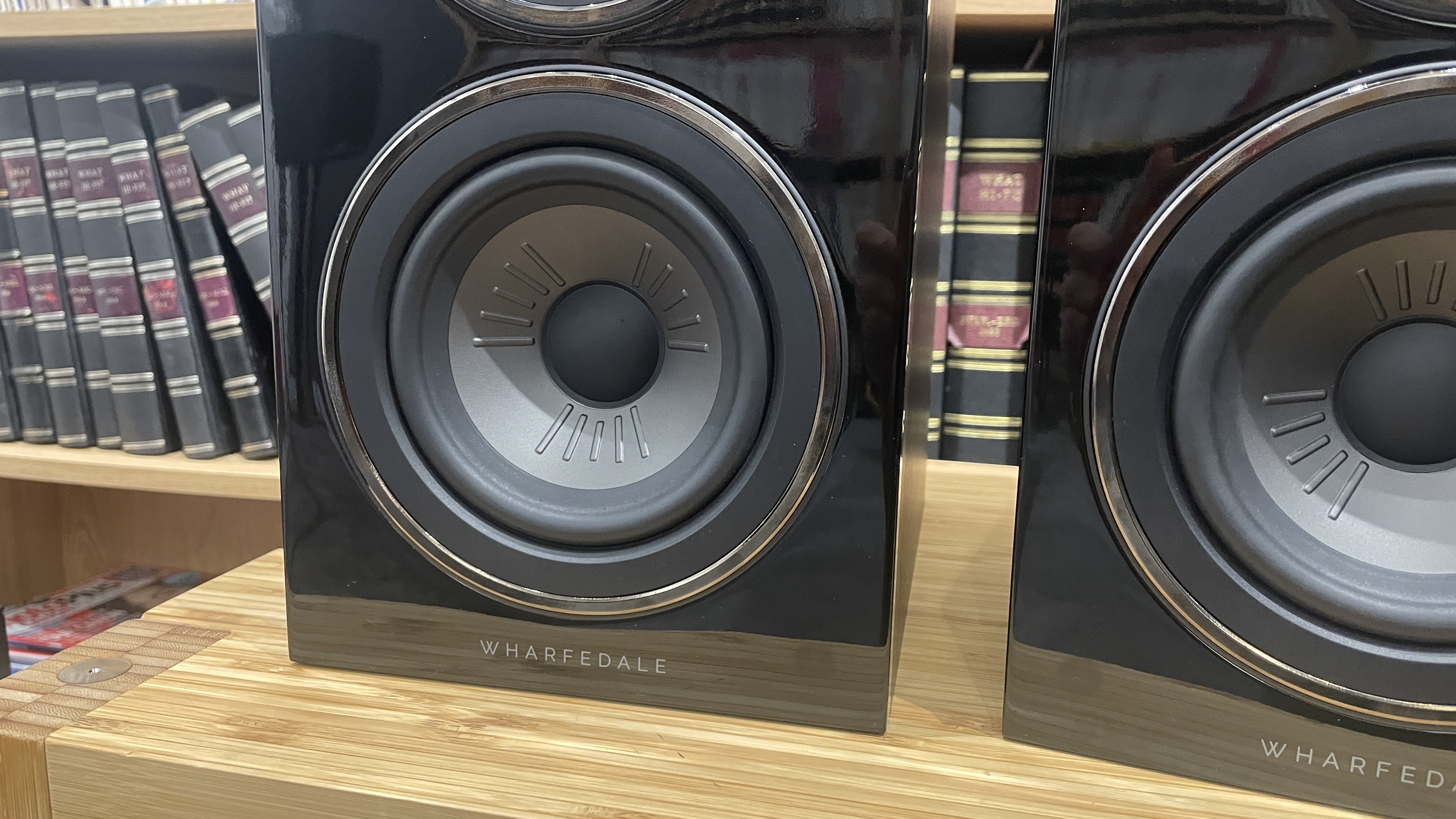 Wharfedale Diamond 12.1 stereo speakers in walnut veneer finish on a wooden rack