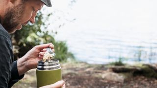 Hiker eating from thermos