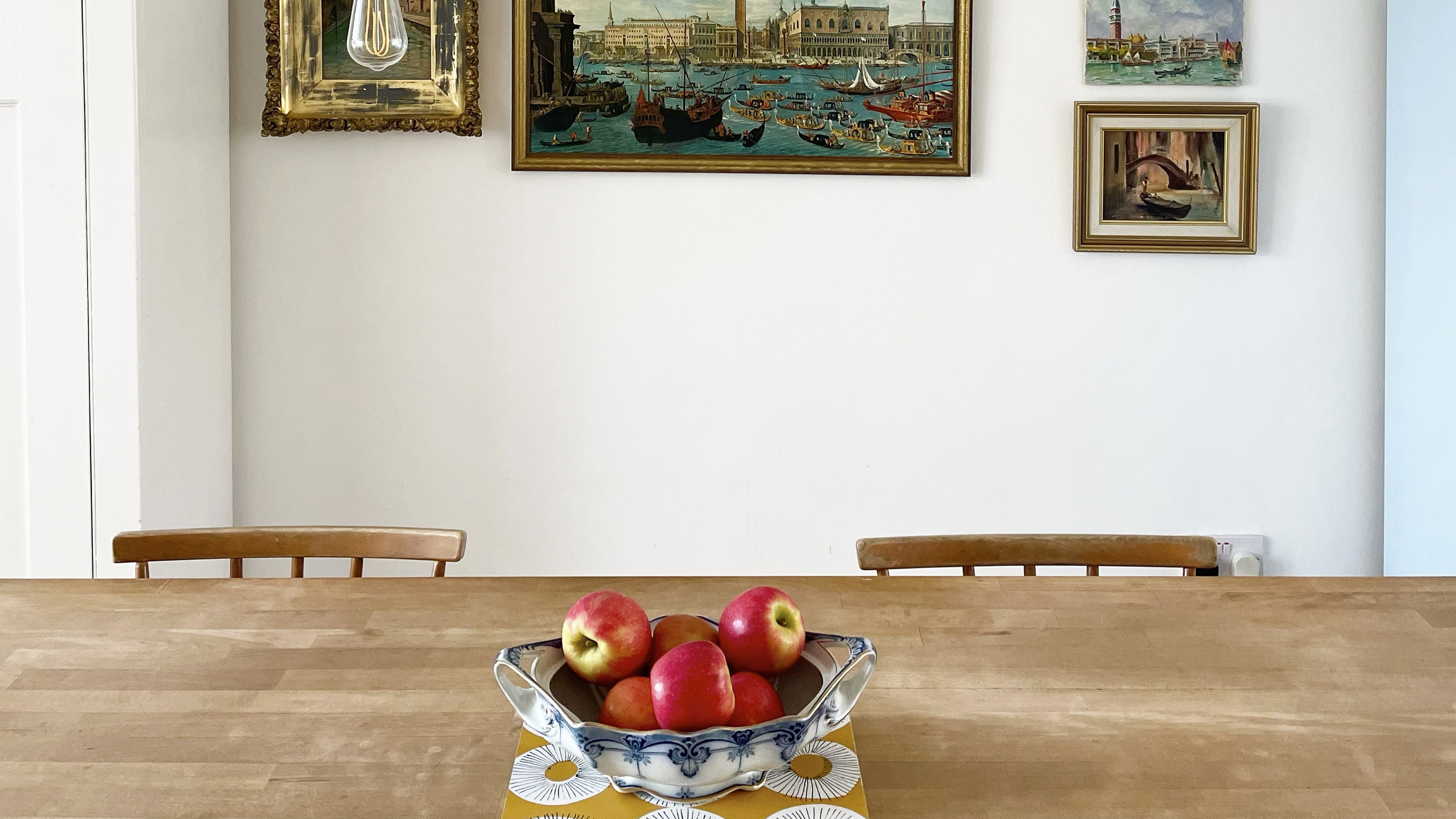 dining table with bowl of apples on it