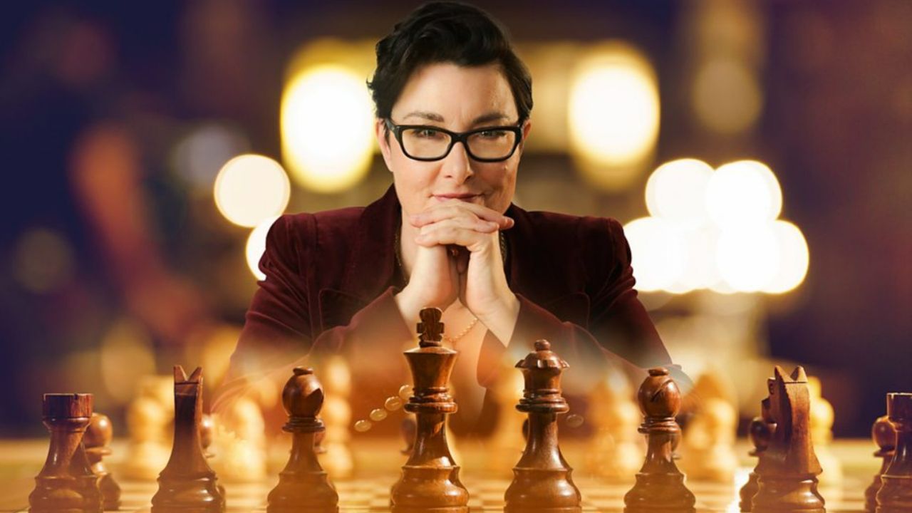 Sue Perkins facing a chess board as the host of BBC Two&#039;s reality gameshow &#039;Chess Masters: The Endgame&#039;