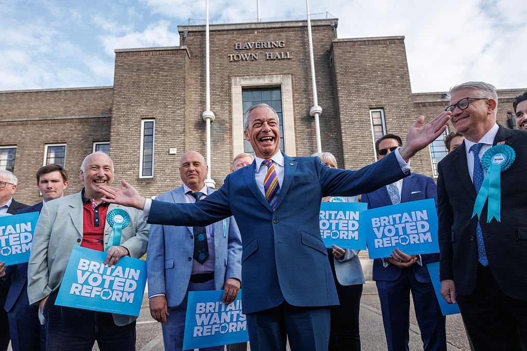 ROMFORD, ENGLAND - MAY 08: Reform UK leader Nigel Farage poses with winning councillors outside Havering Town Hall