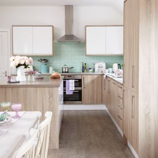 A wood-effect kitchen with flowers on the counter