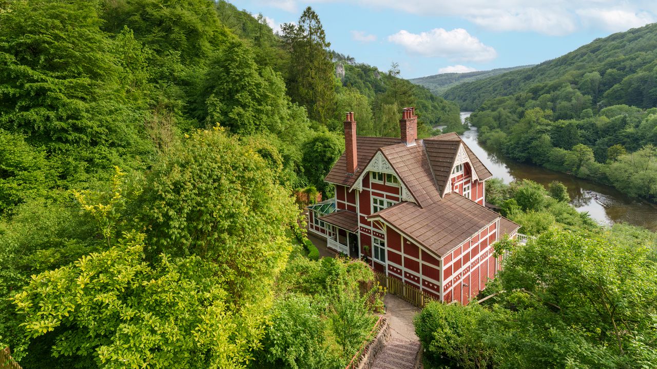 Exterior of chalet lodge surrounded by greenery