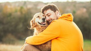 Man hugging his Golden Retriever