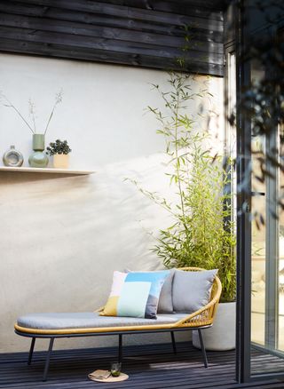 outdoor space with chaise longue and shelf on wall