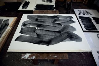 Lee Bae charcoal artwork lies in a studio