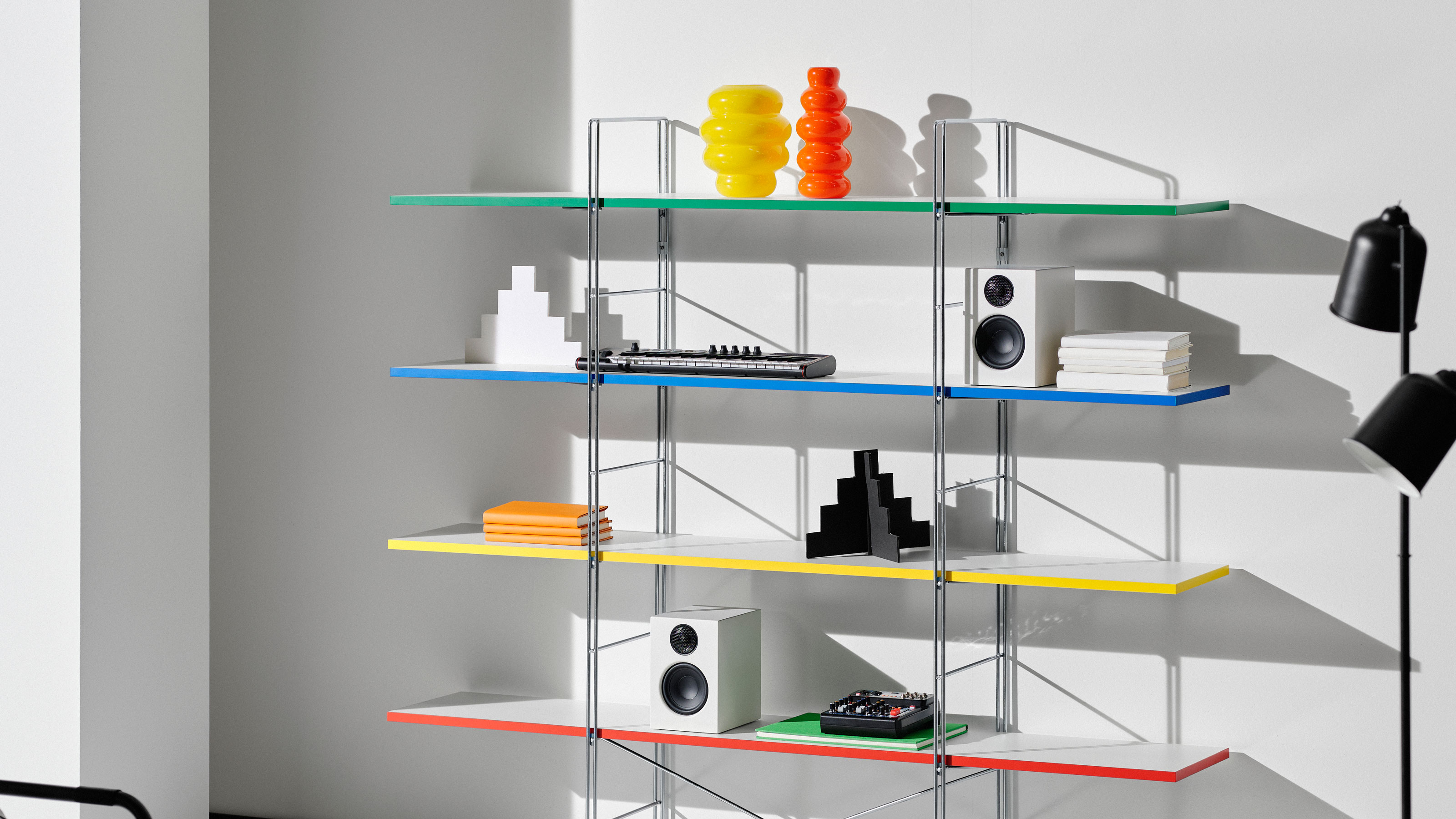IKEA open shelving with coloured edges and metal frame in a white room