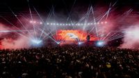 Ayrton light solutions beam across a stage in front of a full house.