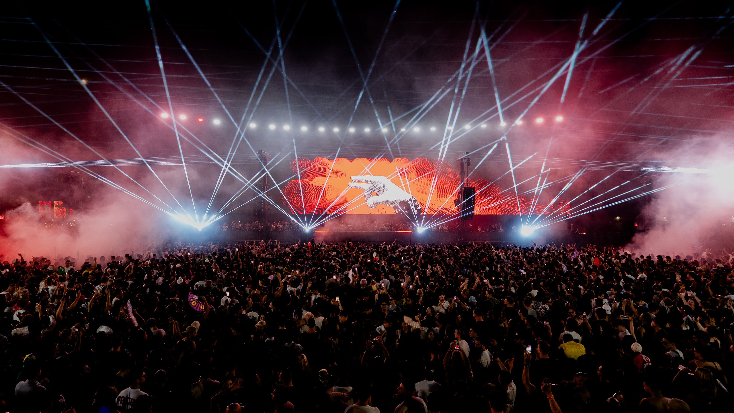 Ayrton light solutions beam across a stage in front of a full house.