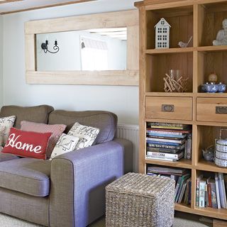 sitting room with wooden cabinet and grey sofa