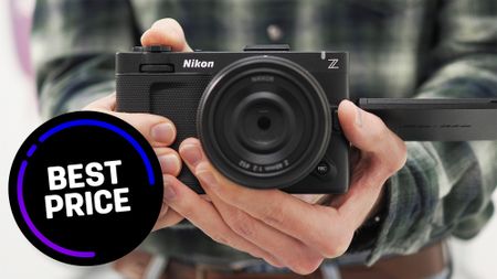 Mike Harris holding Nikon ZR with 'Best Price' roundel in corner 