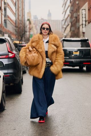 New York Fashion Week attendee wears layered belts.