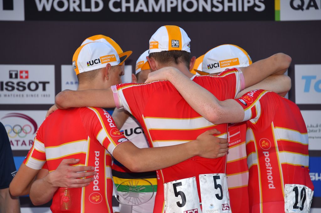 The nations cup winning team celebrate in a huddle