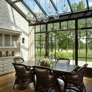 dining room with wall frame and glass roof