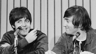 Portland, Oregon: John Lennon (right) smiles as Paul McCartney speaks at the press conference following the Beatles' performance in Portland.