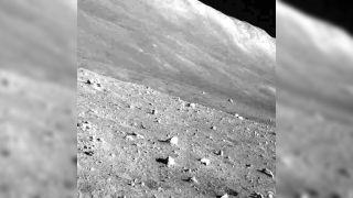 the grey, dusty surface of the moon as seen by a moon lander